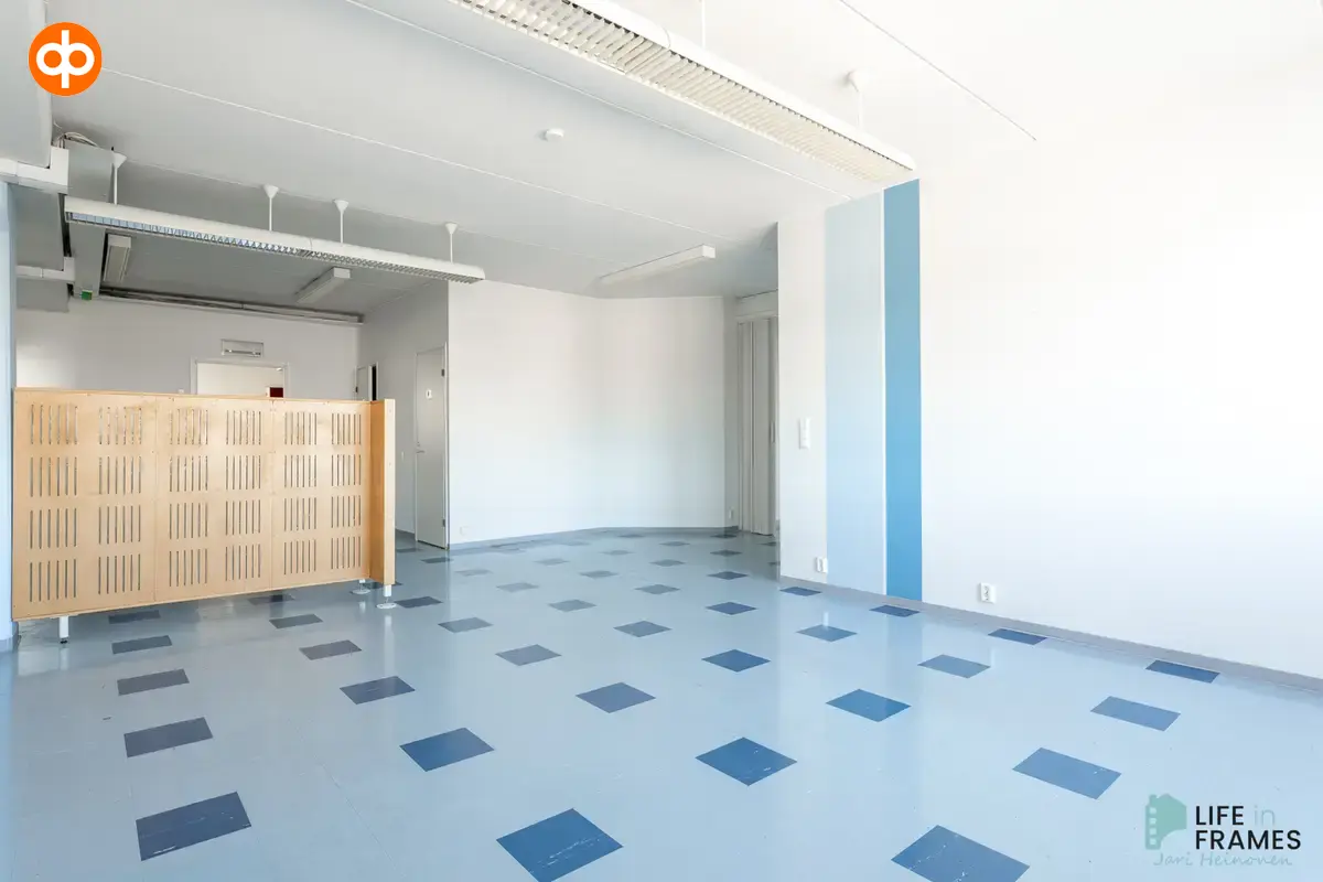 Lauttakylänkatu 4 in Huittinen basic office space with blue vinyl tile flooring.
