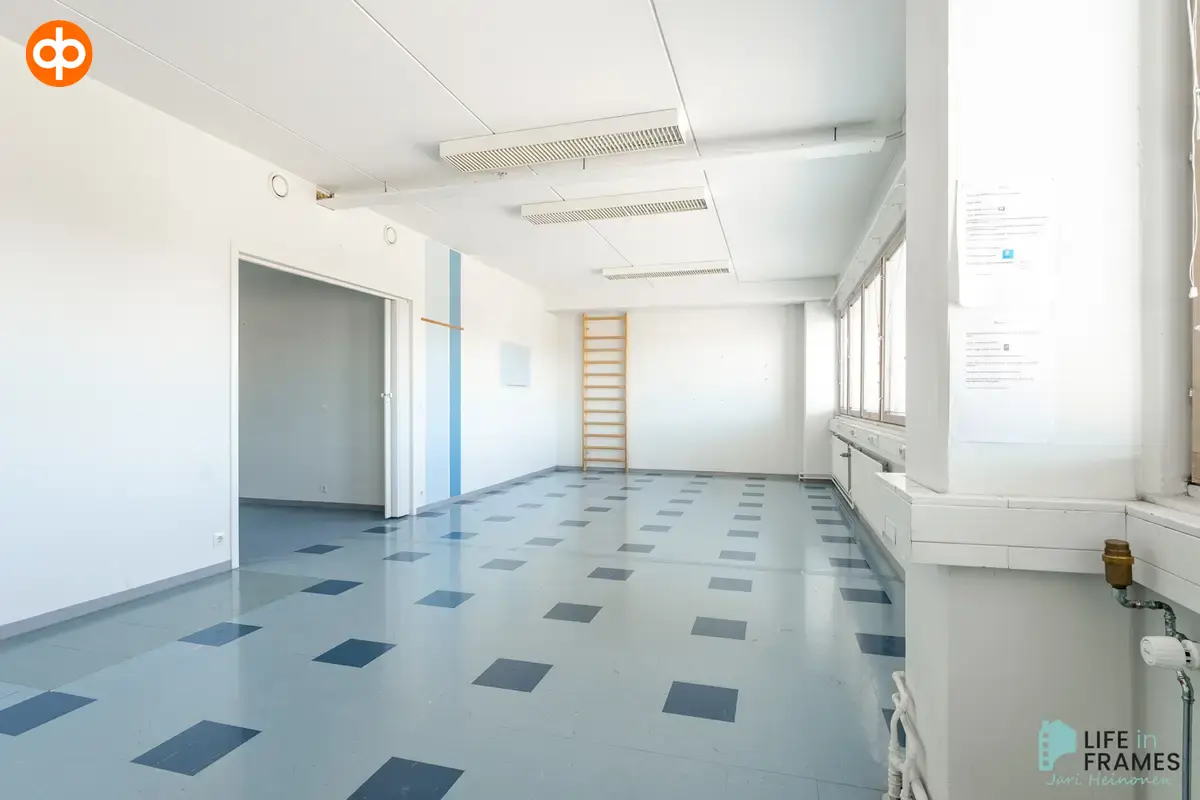 Open office with light blue floor in 322,5 m² office premises on the second floor of Lauttakylänkatu 4 in Huittinen. Wall bars on the back wall.