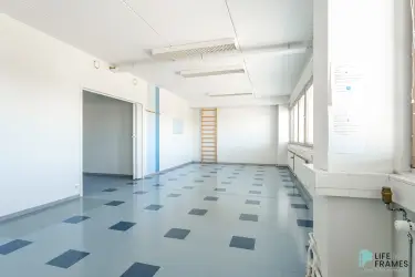 Open office with light blue floor in 322,5 m² office premises on the second floor of Lauttakylänkatu 4 in Huittinen. Wall bars on the back wall.
