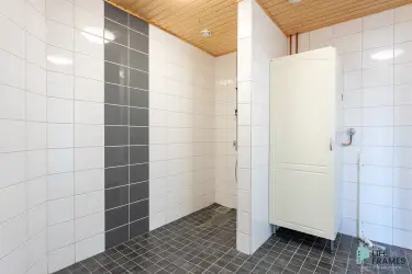 Tiled basic tidy washroom with shower on the second floor 322.5 m² business premises.