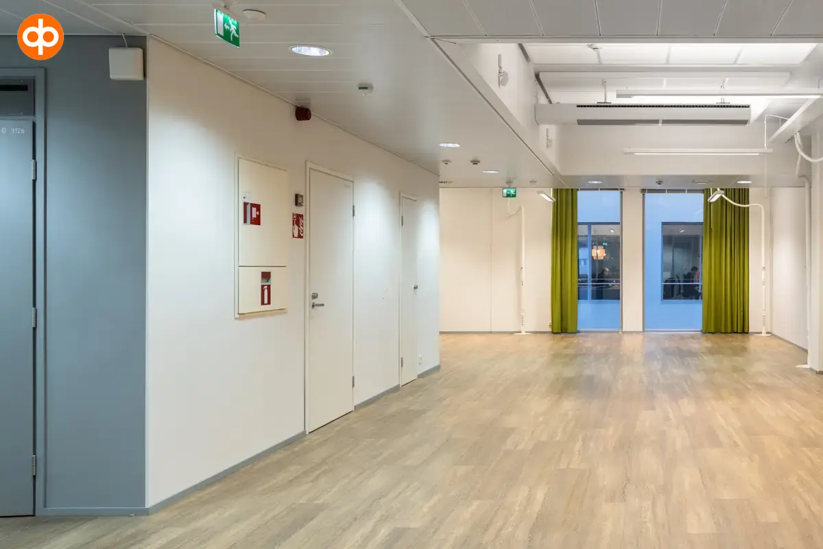 Alberga Business Park – D and E buildings, interior view of the 372.5 m2 office space on the 3rd floor. Empty open-plan office. Wooden floors and white walls. Two doors on the left wall.