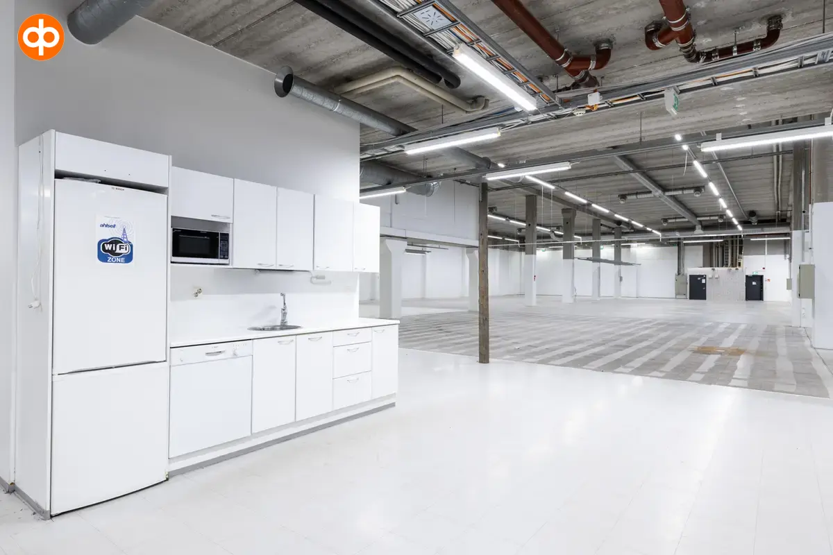 Interior view of the commercial property at Silvastintie 1, Vantaa. A light kitchen with an open storage space next to it.