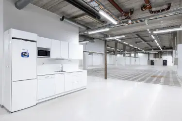 Interior view of the commercial property at Silvastintie 1, Vantaa. A light kitchen with an open storage space next to it.