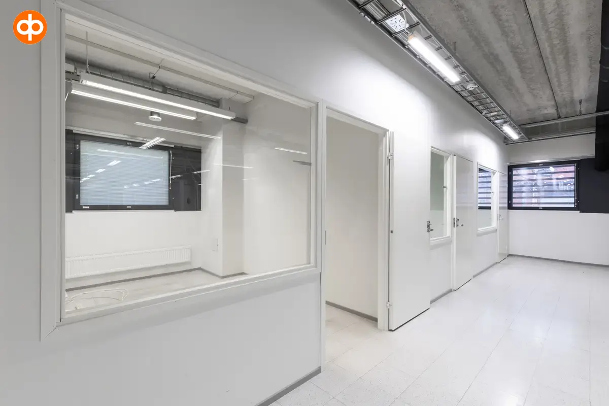 Interior view of the 3278 m2 office space on the 1st-2nd floor of Silvastintie 1, Vantaa. Office space with two separate office rooms next to each other. The floors and walls of the space are white.