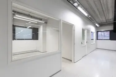 Interior view of the 3278 m2 office space on the 1st-2nd floor of Silvastintie 1, Vantaa. Office space with two separate office rooms next to each other. The floors and walls of the space are white.