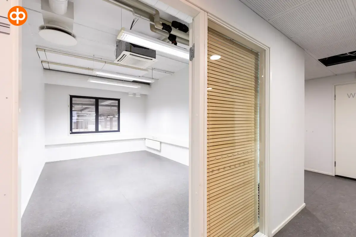 Interior view of the 3278 m2 office space on the 1st-2nd floor, Silvastintie 1, Vantaa. Empty office room with a window facing the street. There is a window on the back wall that shows the storage spa