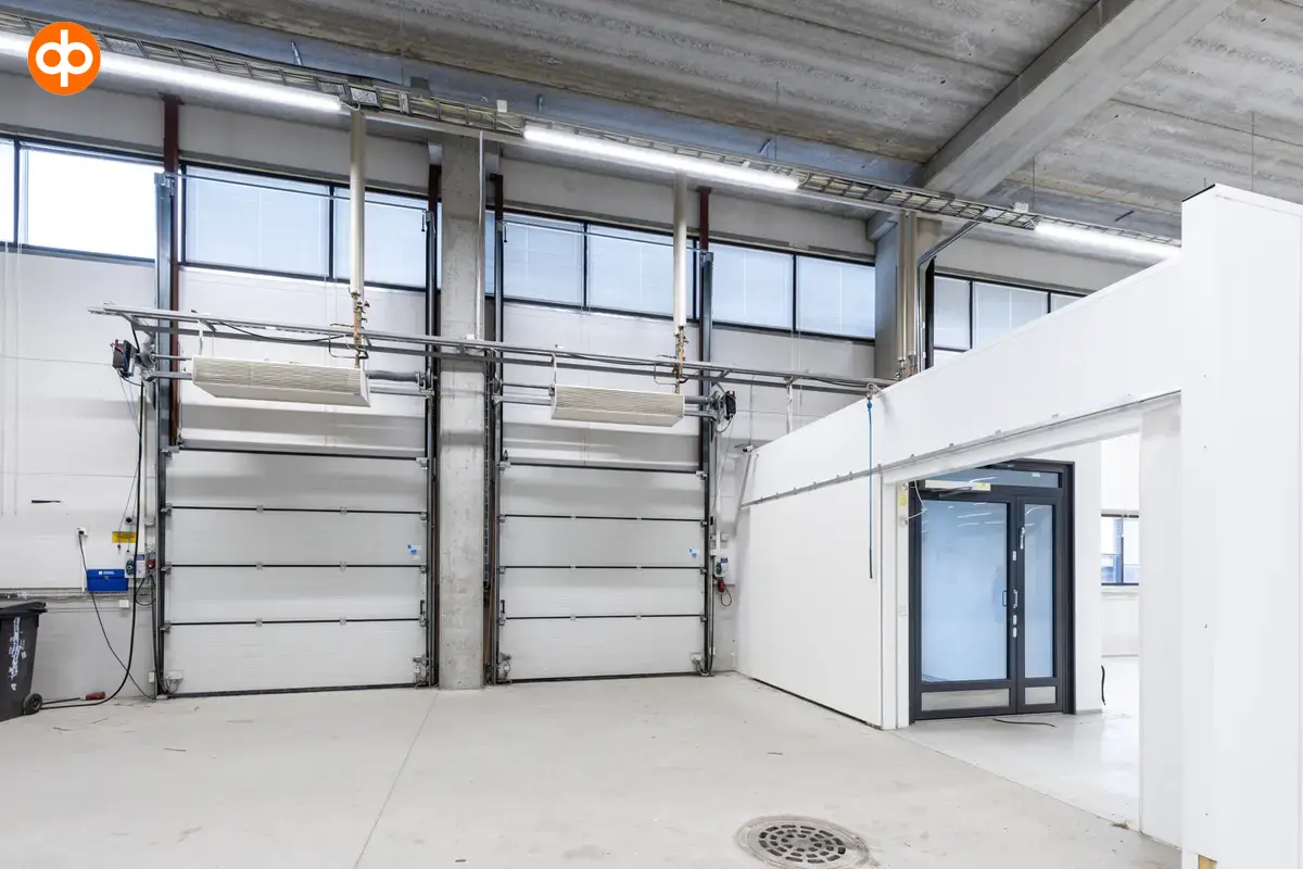 Vantaa Silvastintie 1, 1st floor storage room with two lifting doors next to each other. Next to the lifting doors is a normal glass door.