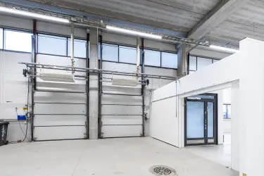 Vantaa Silvastintie 1, 1st floor storage room with two lifting doors next to each other. Next to the lifting doors is a normal glass door.