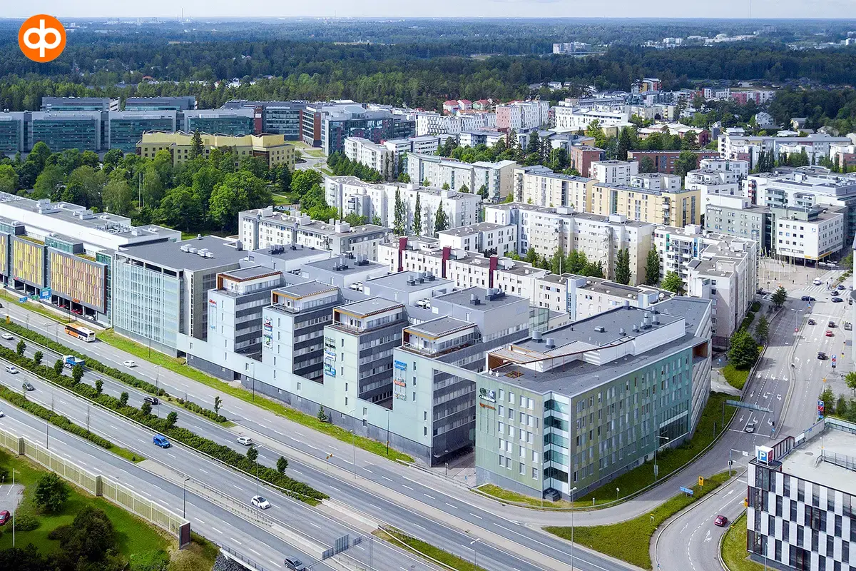 Alberga Business Park – D building photographed from the air. A large light gray property by the highway. Other buildings behind.